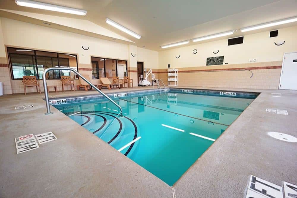 a view of the indoor swimming pool with bright blue water and a clean facility